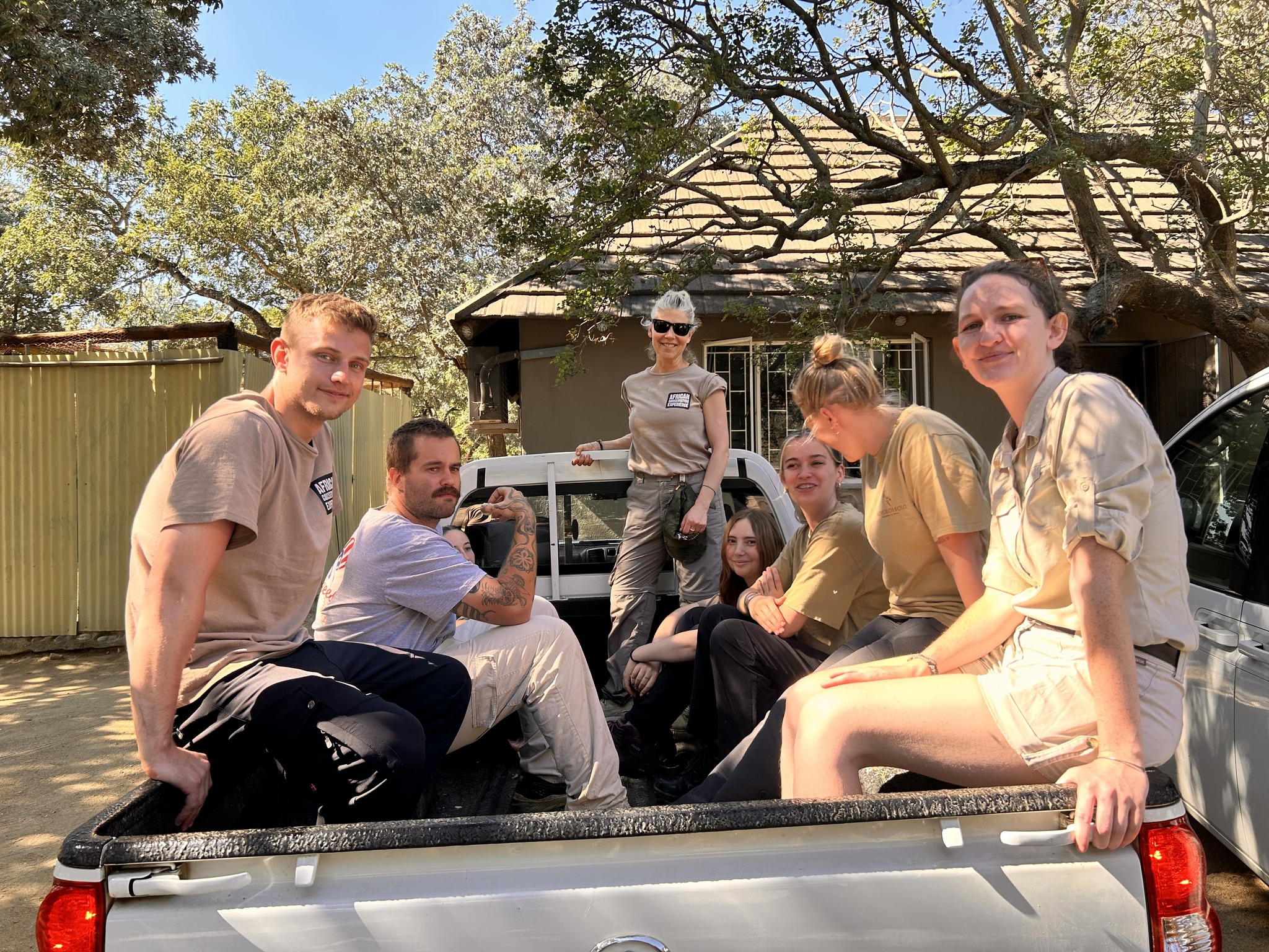 Katie Marshall - volunteers posing on the back of a vehicle 