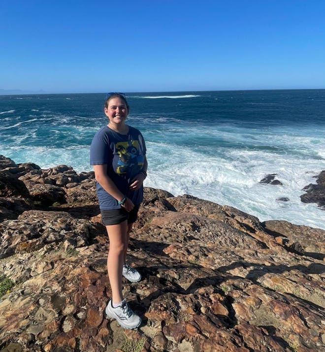 Volunteer Adriana Gomez Jackson poses in front of the sea