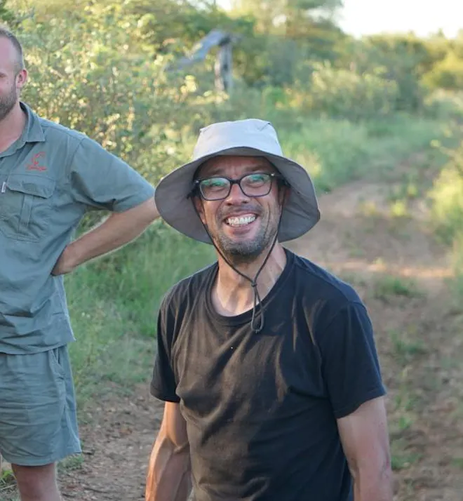 Juan Linares: volunteer smiling at the camera in the bush