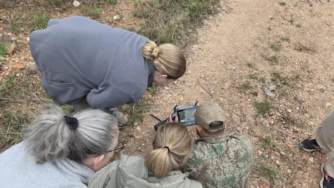 Katie Murray: Group learning about tracking from project staff at Vikela