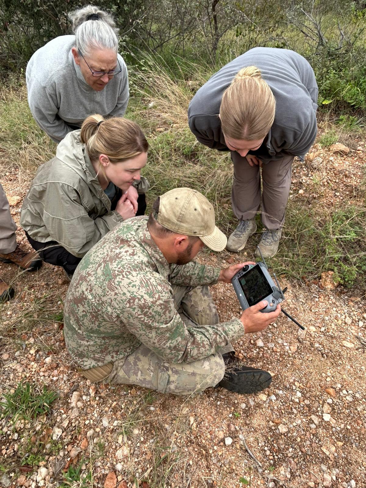MaryClaire Murray - Volunteers learning how to track animals from anti-poaching specialist at Vikela