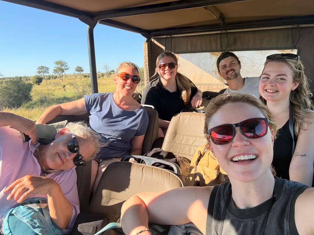 MaryClaire Murray - Group photo of volunteers on game drive vehicle