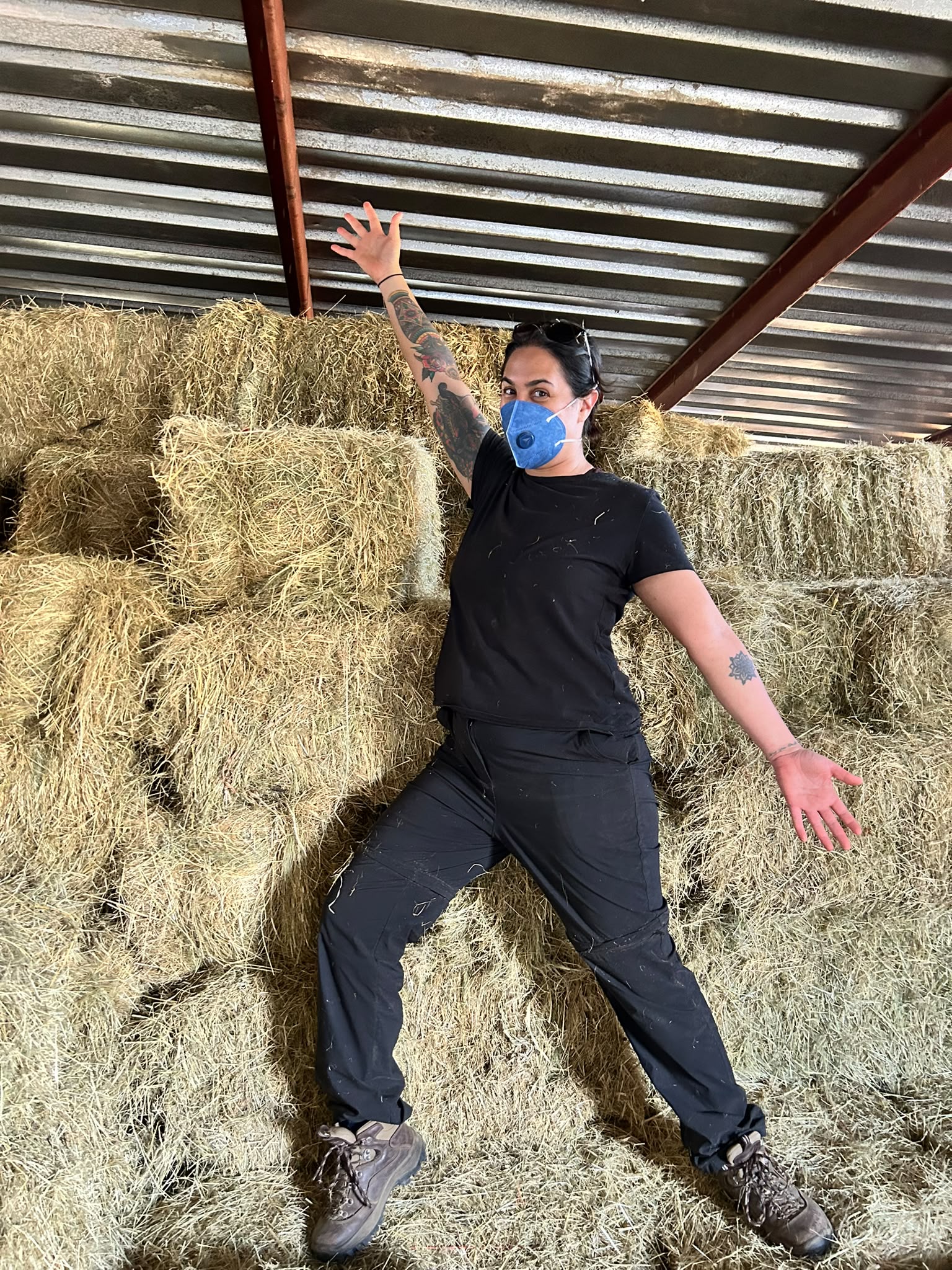 Natalie Gibbings - Posing in front of hay bales at Golola Rhino Orphanage