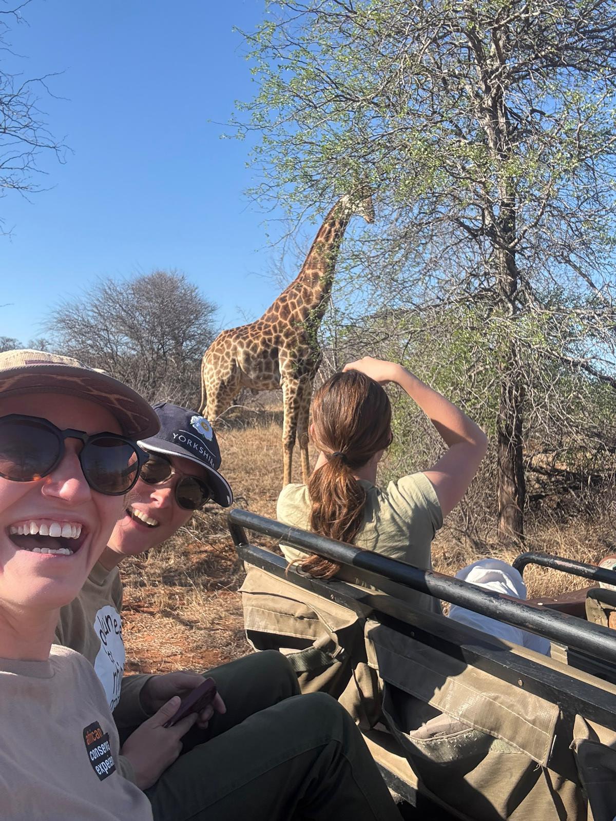 Iris Walling: volunteer posing with a giraffe in the background