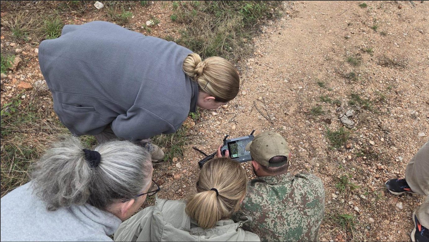 The Vikela Kruger Conservation Experience: volunteers looking at a drone and tracks