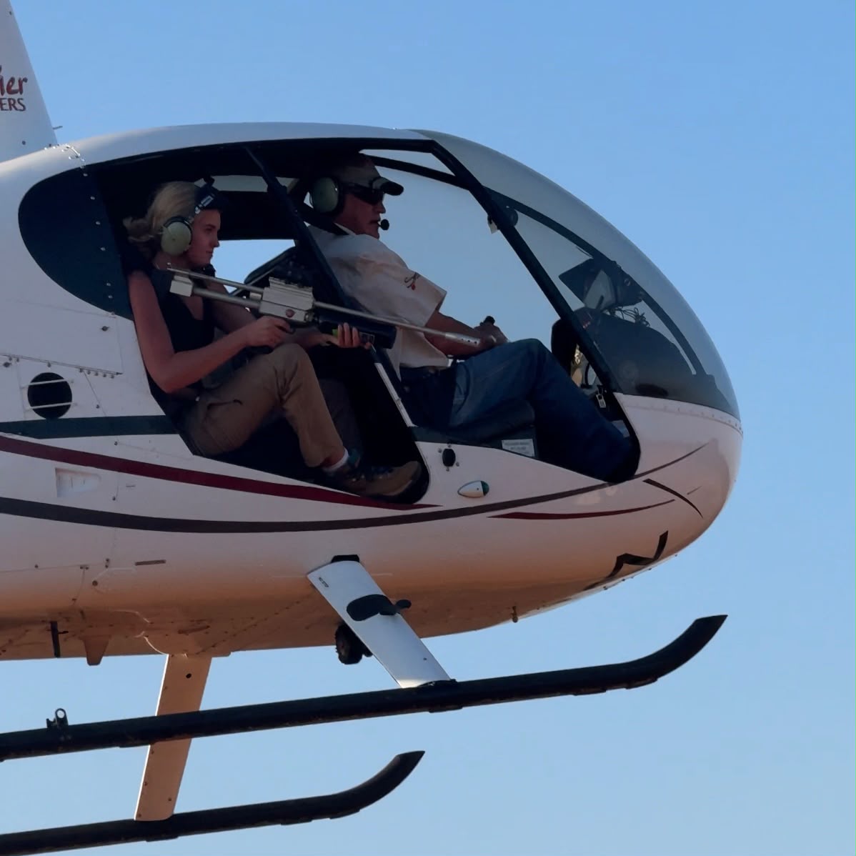 Samantha Collett in a helicopter practising her darting skills