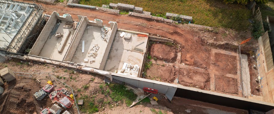 Plots 127–132 are progressing through their foundation stages, while completed homes can be seen opposite, showing the full range of activity across the site.