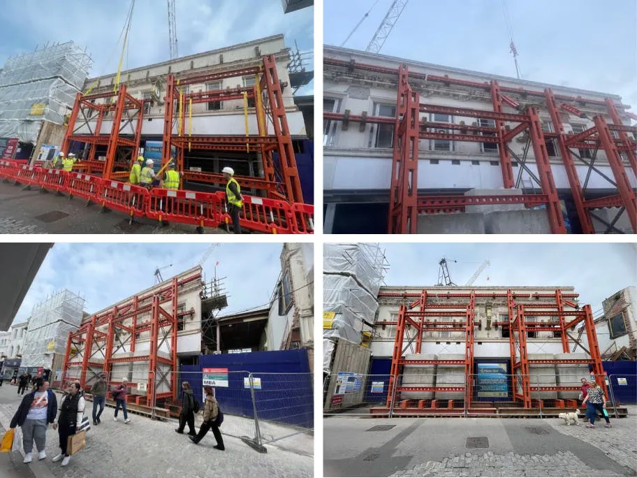 The original façade is held in place by steel supports, preserving its character while construction progresses behind it.