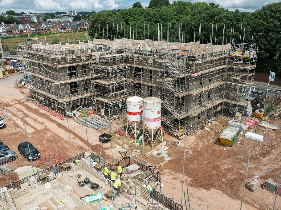 Masonry work on the main apartment in block A is now at full height, with scaffolding supporting final structural touches before removal begins.