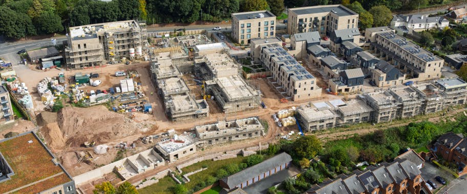 A zoomed-out view of St Leonards Quarter, illustrating the scale of the development as multiple apartment blocks and houses progress simultaneously across the site.