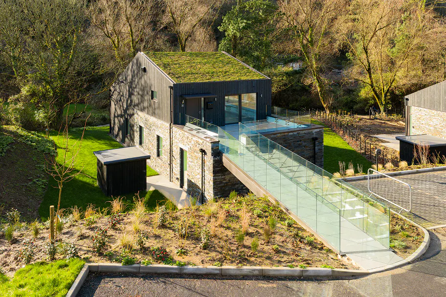 With its glass bridges and turf roofs, the Lee Bay development sits seamlessly within its natural surroundings.