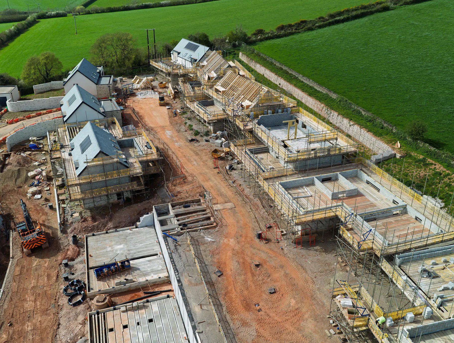 Further down the site, the elevations are rising steadily with some plots already reaching roof truss stage.