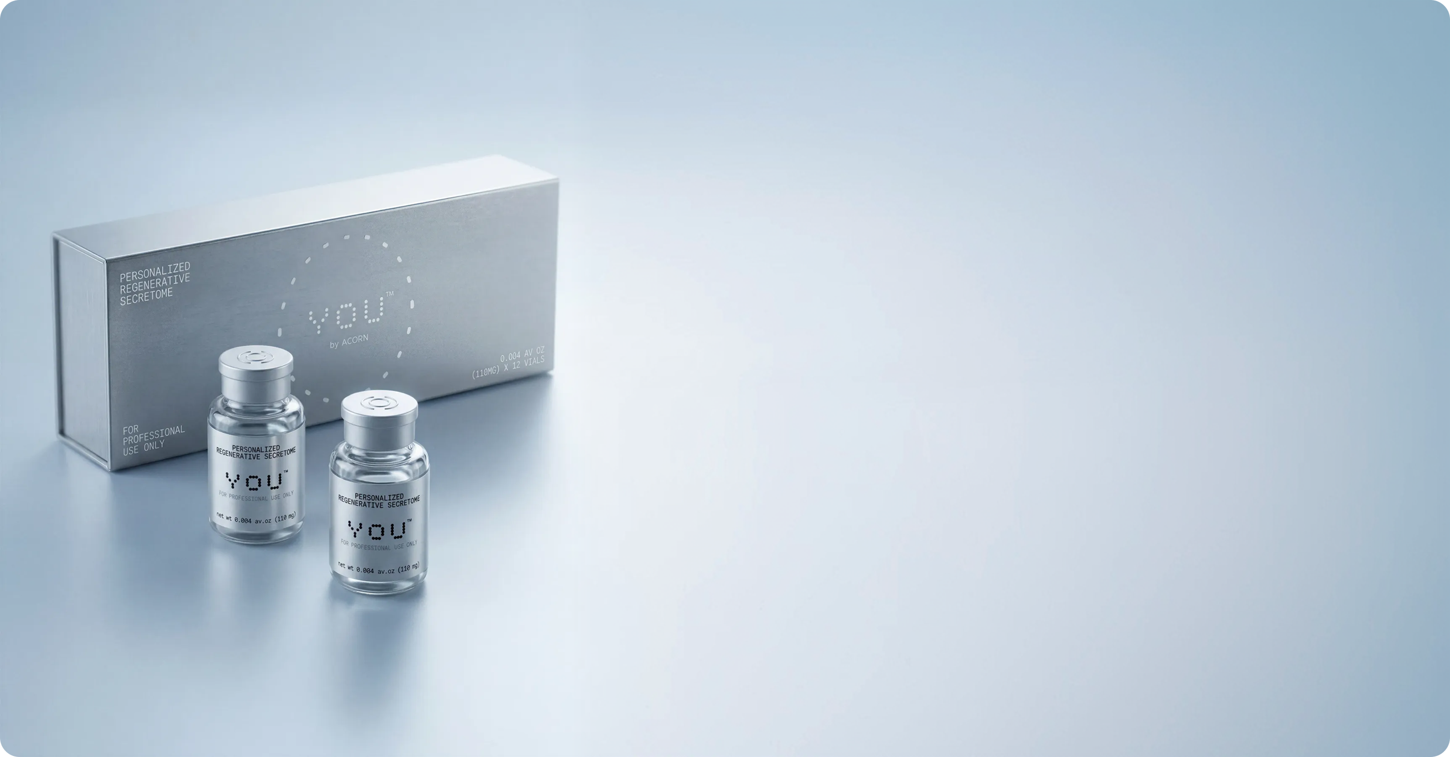 Two bottles of regenerative secretome serum beside a decorative box, showcasing an elegant packaging design.