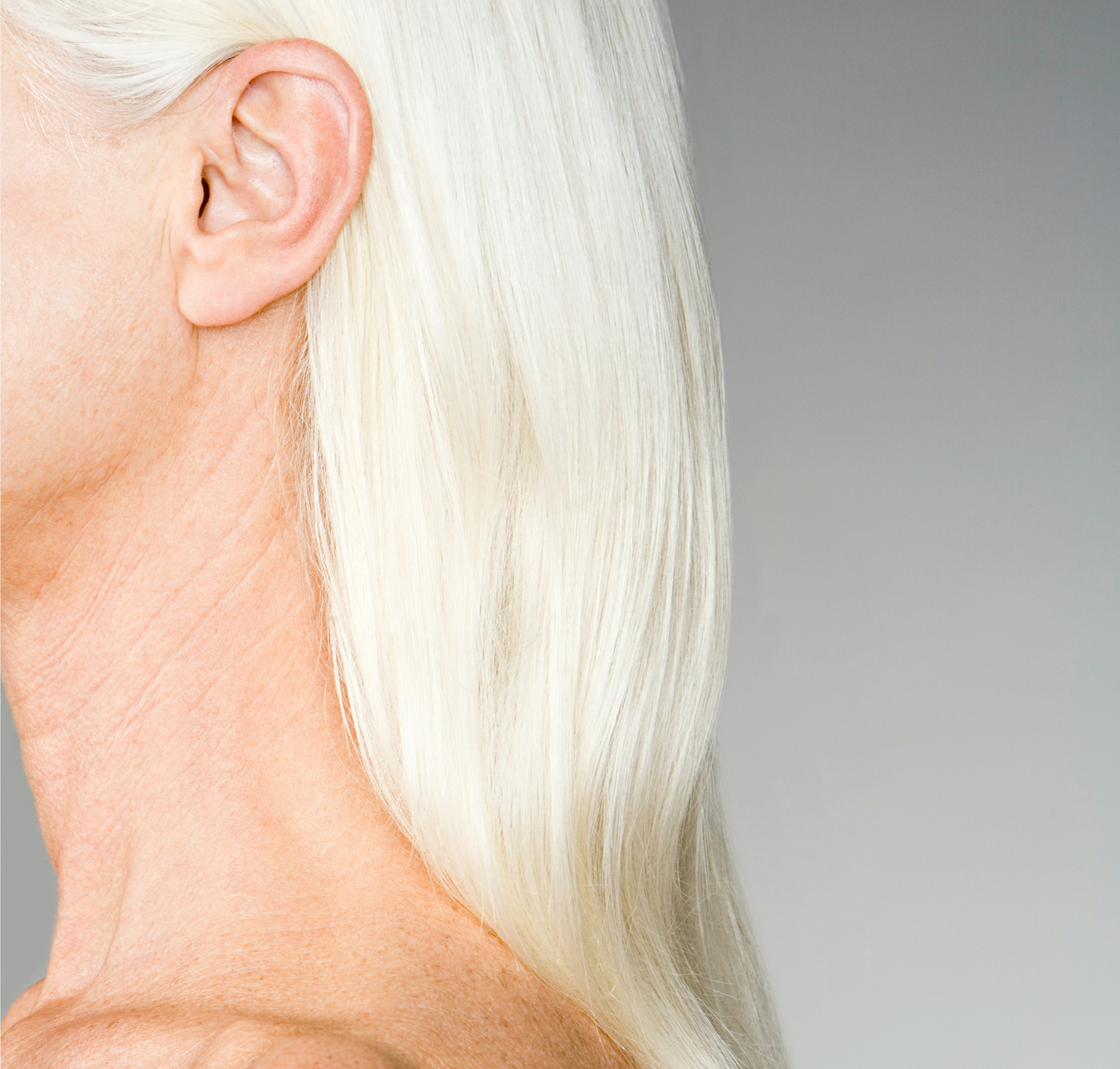 A woman with long, white hair, captured in a calm and elegant pose.