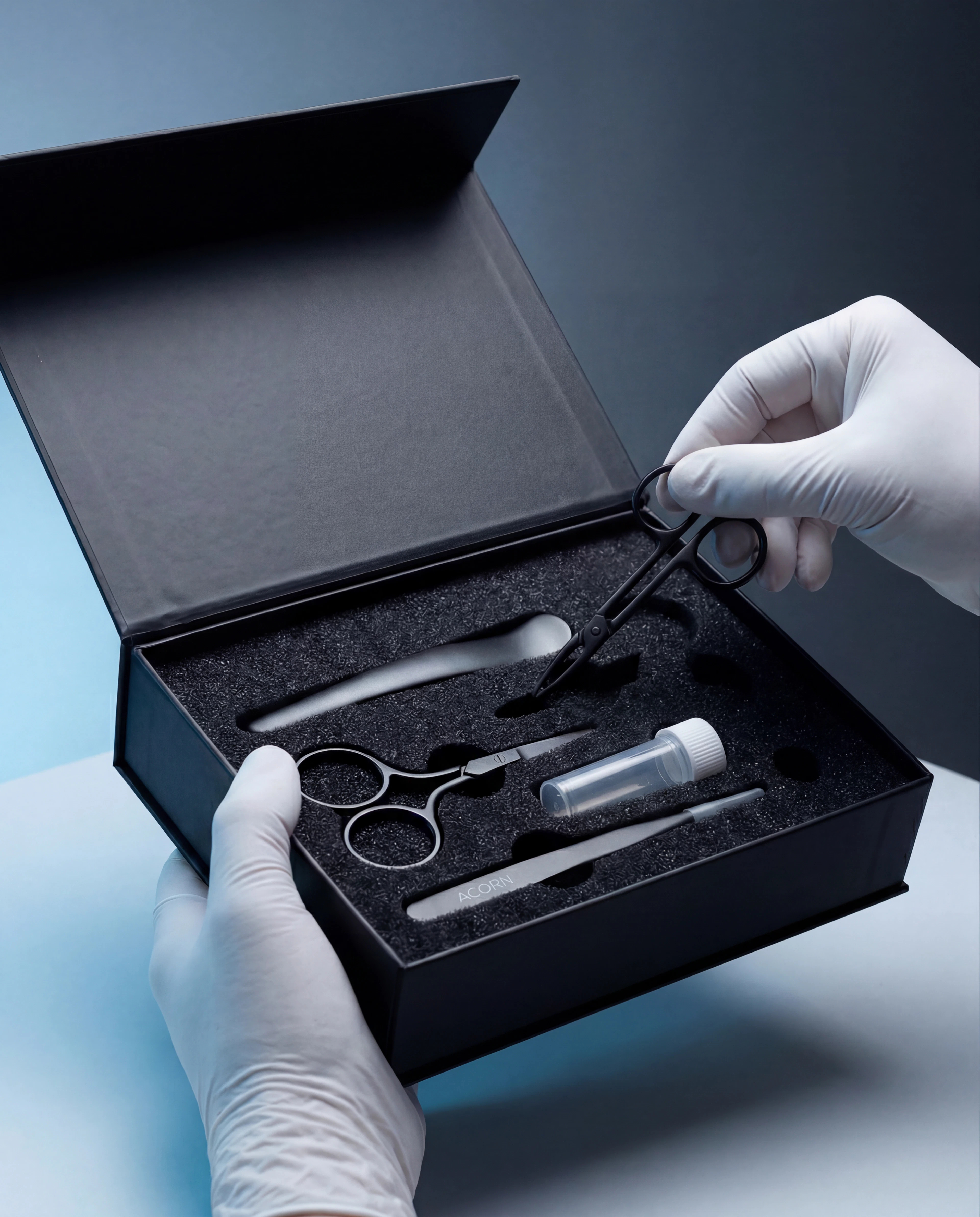 A person holding scissors next to a collection kit box, ready to use the tools inside.