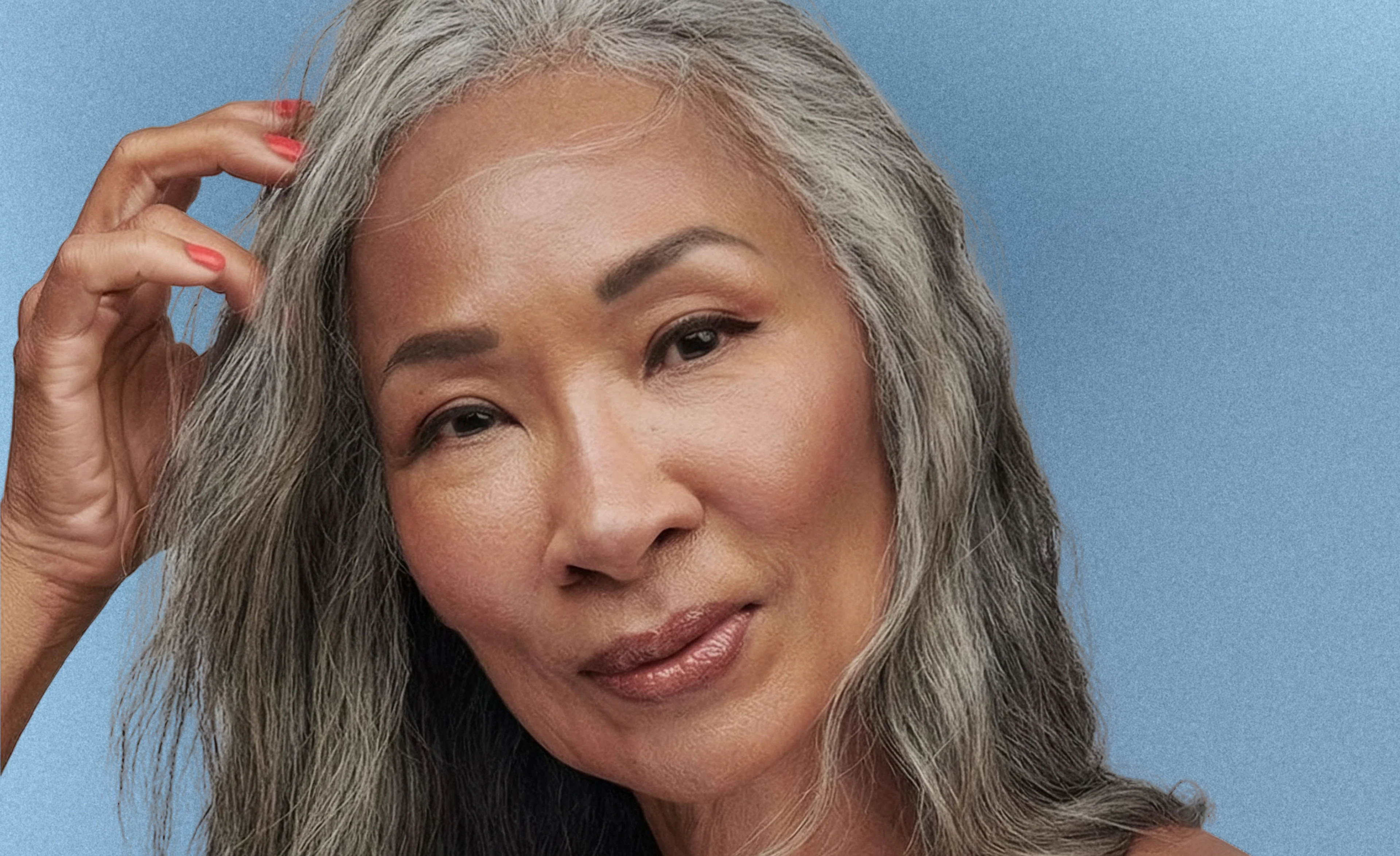An older woman with gray hair, smiling warmly at the camera.