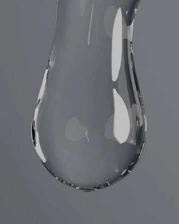 A clear serum, floating against a soft, blurred background.