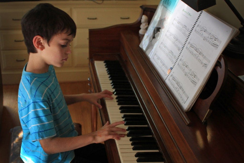 Boy Playing Piano With Good Posture