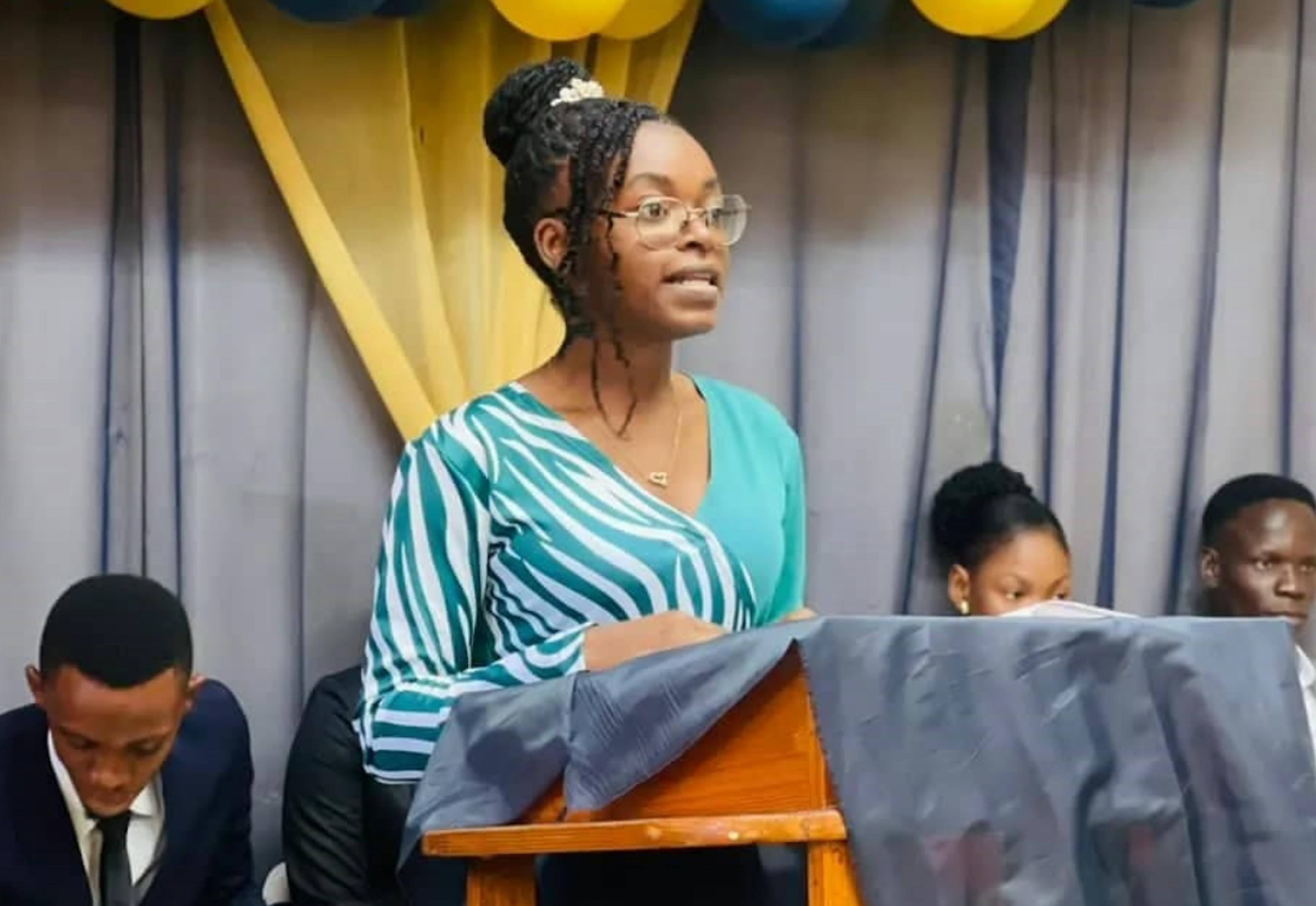 Haitian student behind a podium