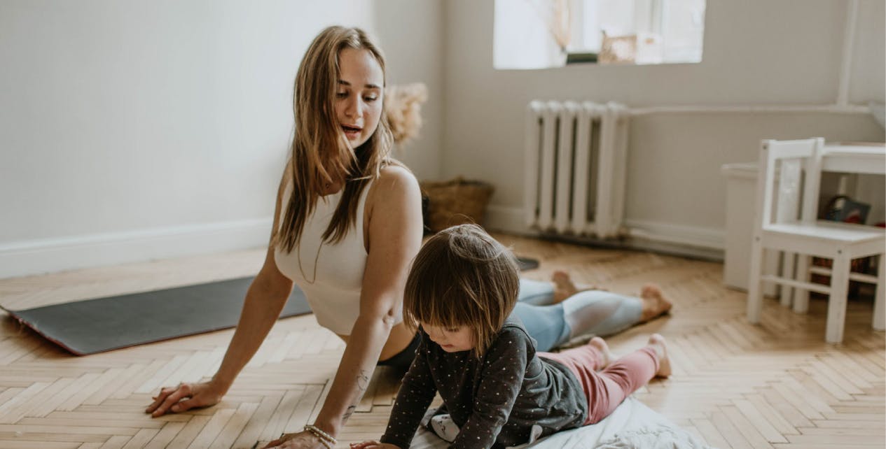 Woman and daughter exercising together at home