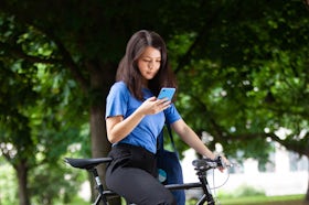 A cyclist checking the Ada app on the phone