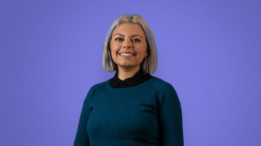 Ada's new Spanish language copywriter, Elba, in front of a purple background.