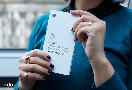 Photo shows Elba holding a personalized welcome booklet on her first day.