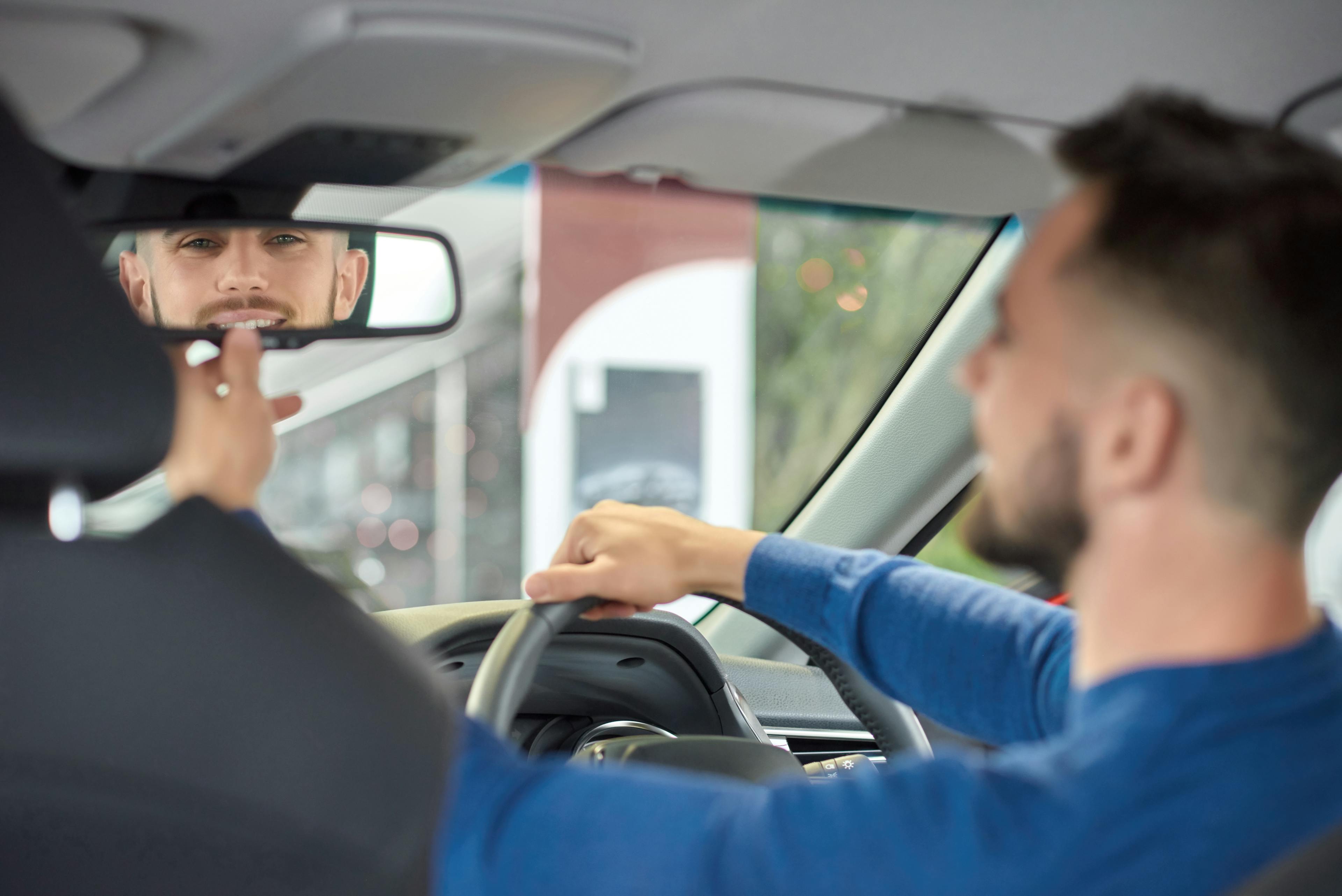 A learner being taught how to use their mirrors correctly after driving instructor training