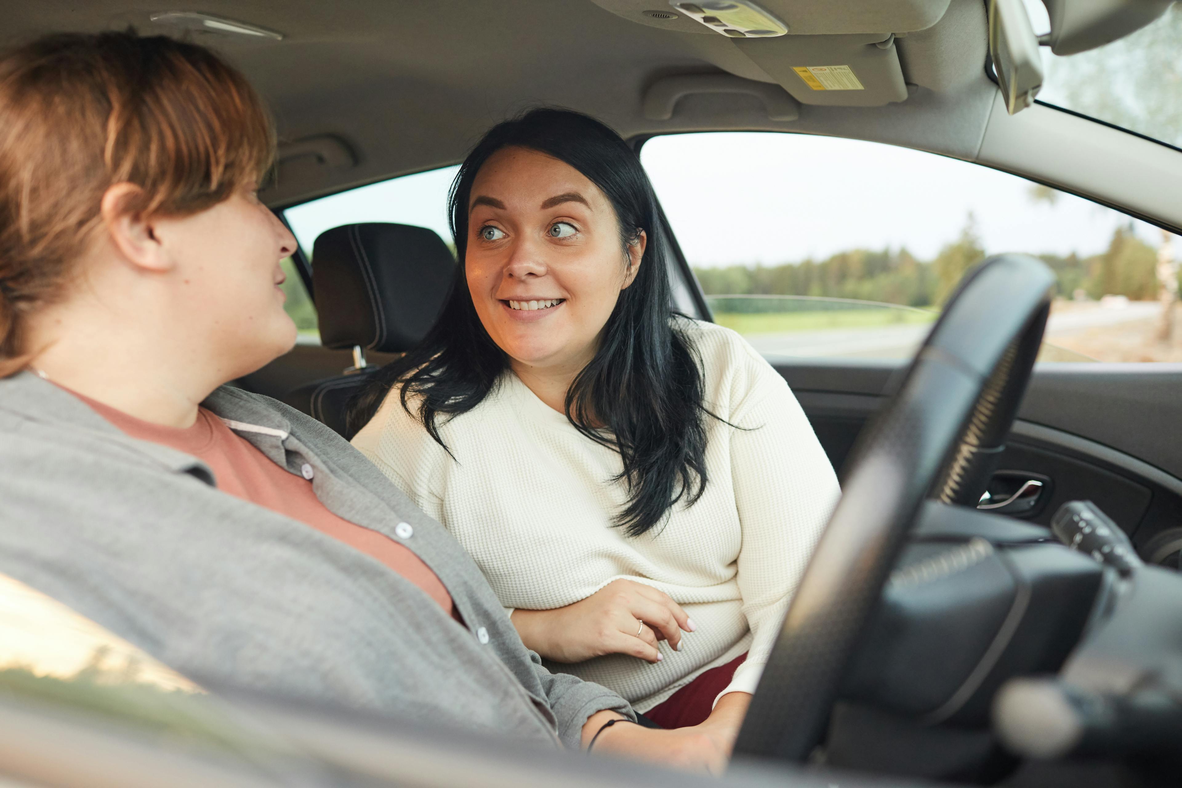 Driving instructor coaching a female learner driver