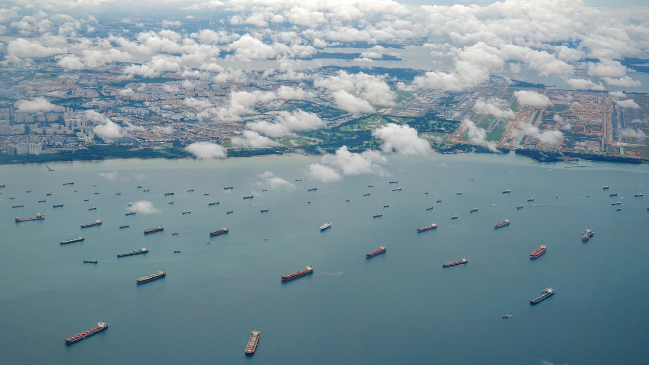 Fleet of container ships heading toward harbor, symbolizing international supply chains and wholesale import of electronic parts and components.