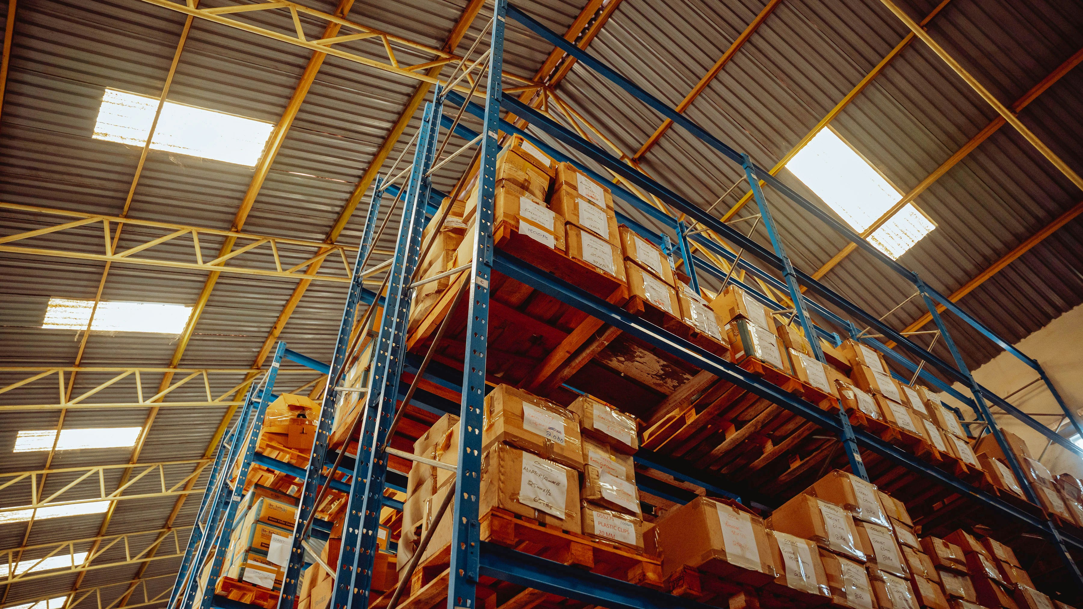 High-bay warehouse storage system filled with pallets of electronic components, showcasing efficient logistics and bulk inventory management in wholesale distribution