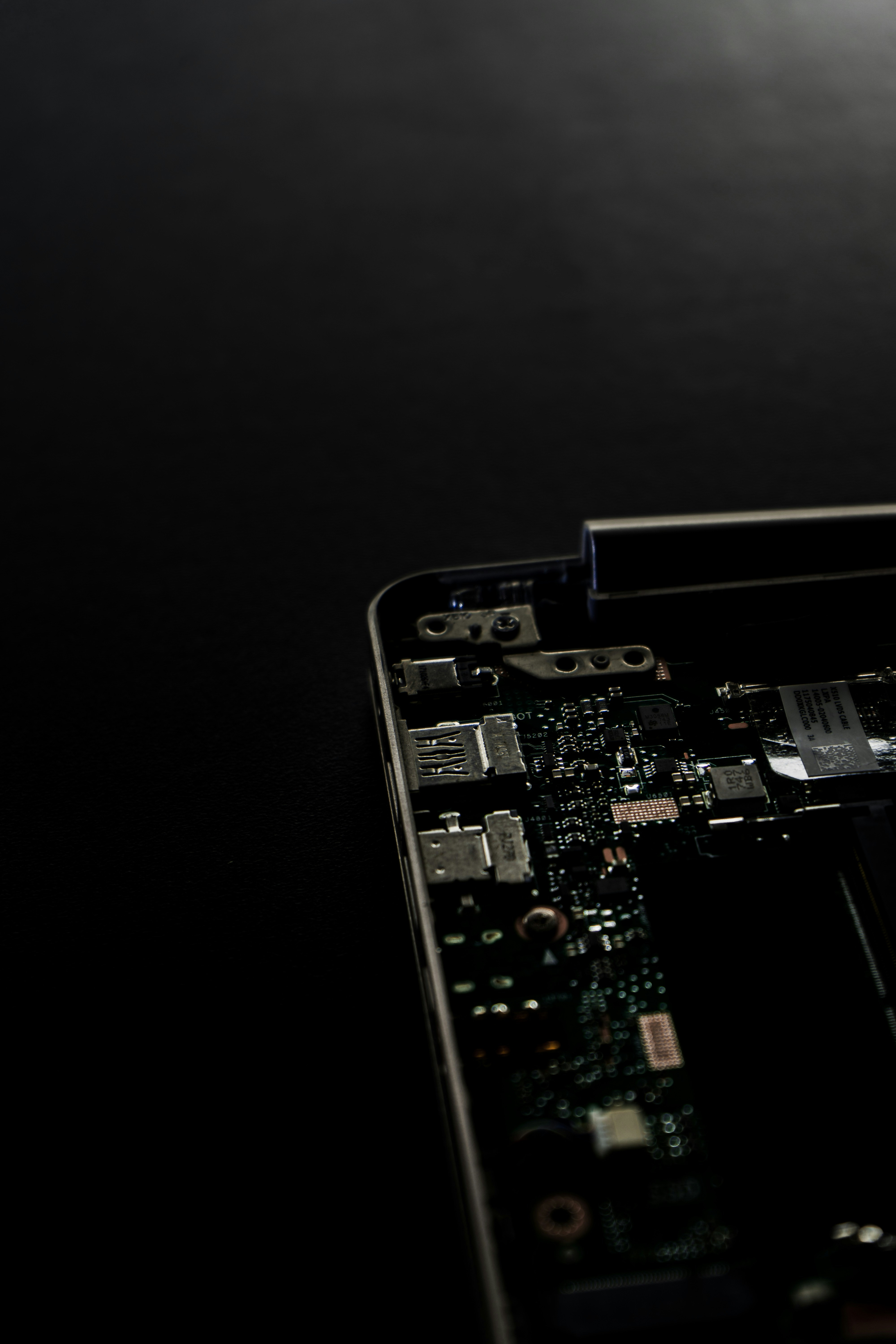 Printed circuit board (PCB) with various electronic components on a black background, symbolizing reliable, precise, and high-quality engineering in electronics manufacturing.