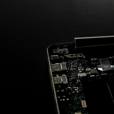 Printed circuit board (PCB) with various electronic components on a black background, symbolizing reliable, precise, and high-quality engineering in electronics manufacturing.