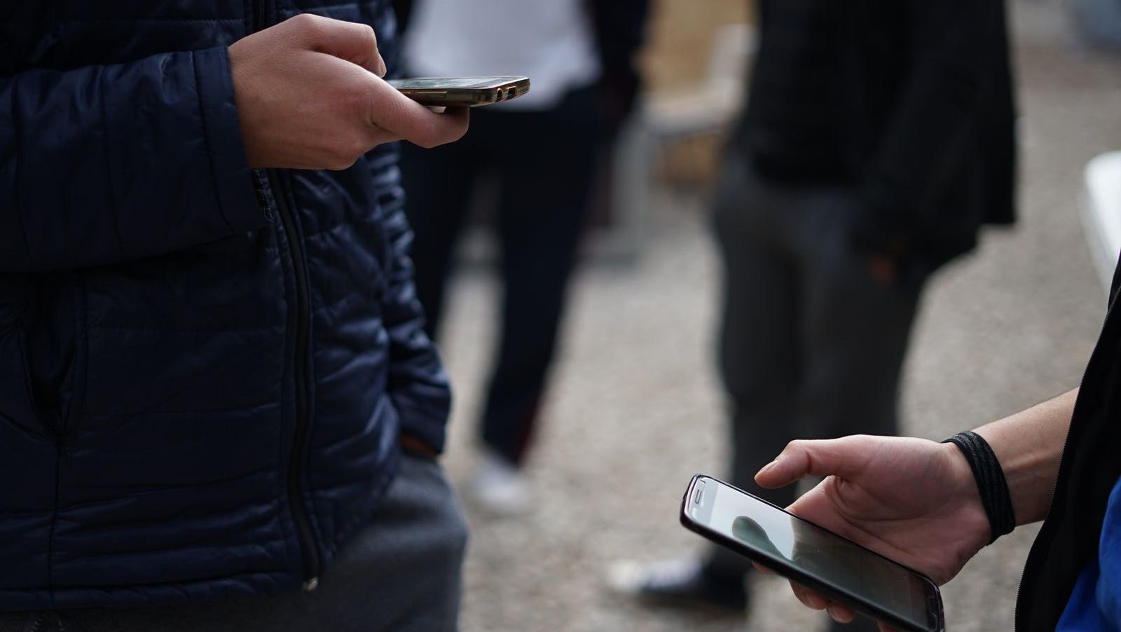 two people on their mobile phones