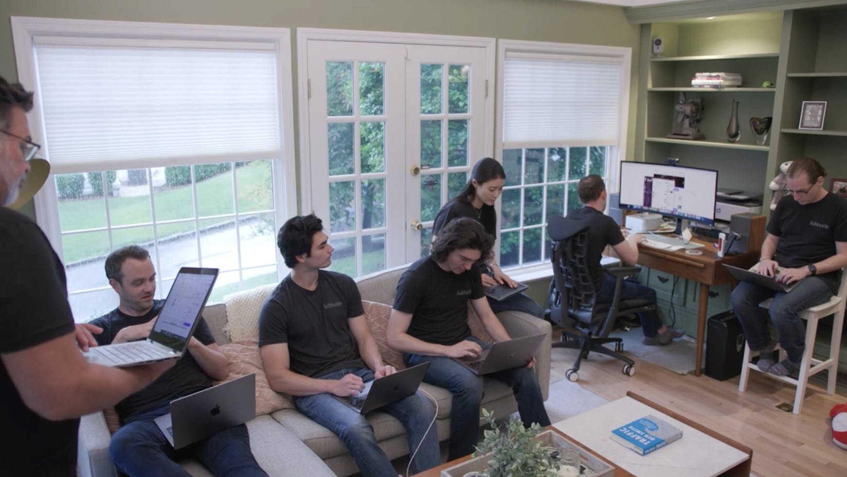 A group of Aditude employees working in Jared's living room