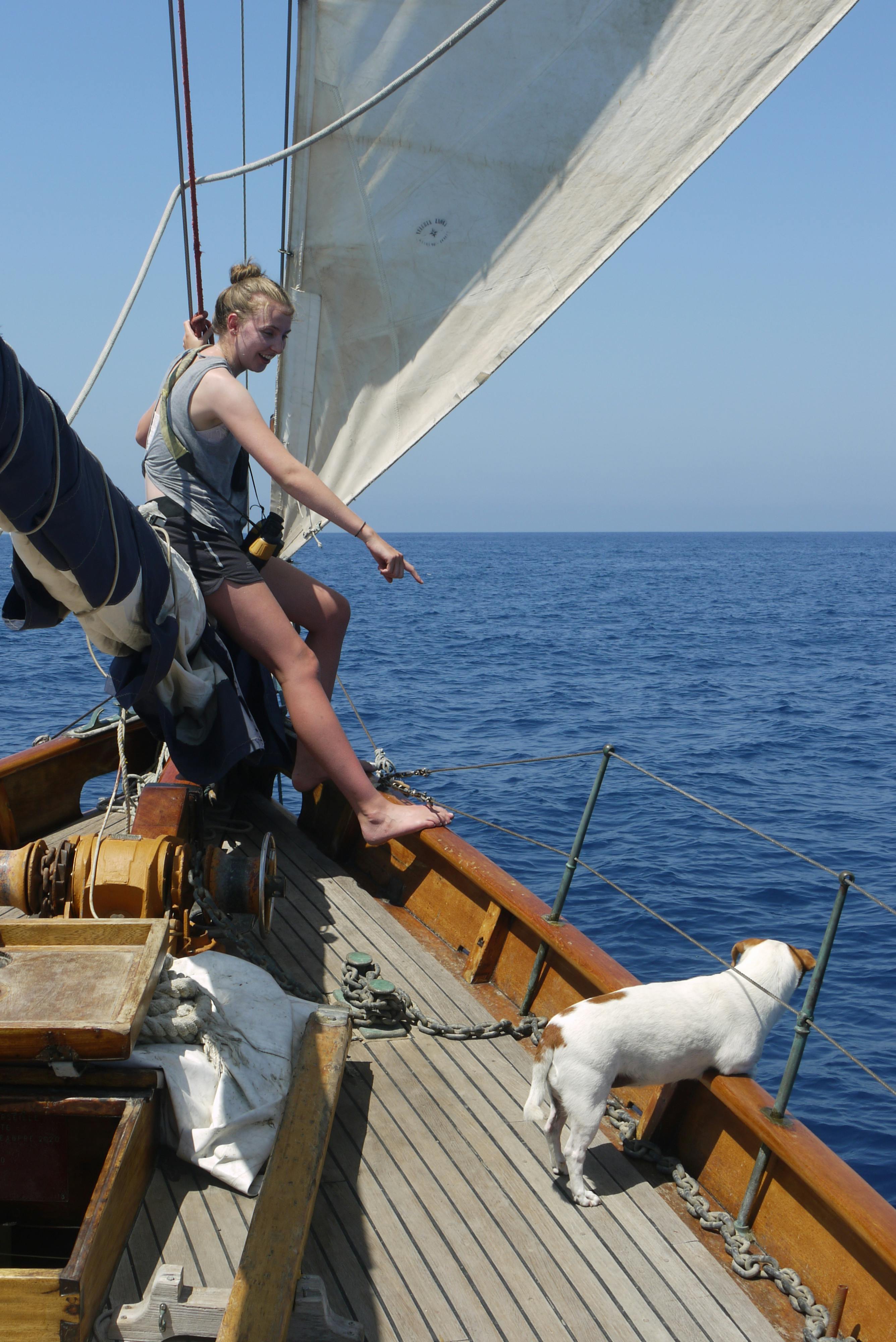 Emmie on the help of a sailboat with a small dog. 