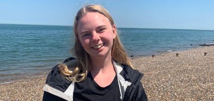 Linn smiling on the beach