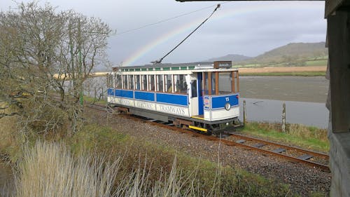 Trains passing by with a rainbow in the background