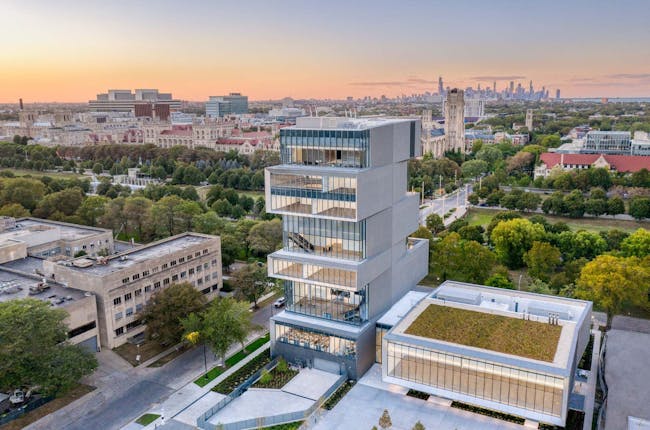 an aerial view of the Rubenstein Forum building with downtown chicago in the distance