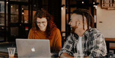 Man and woman collaborating with laptop