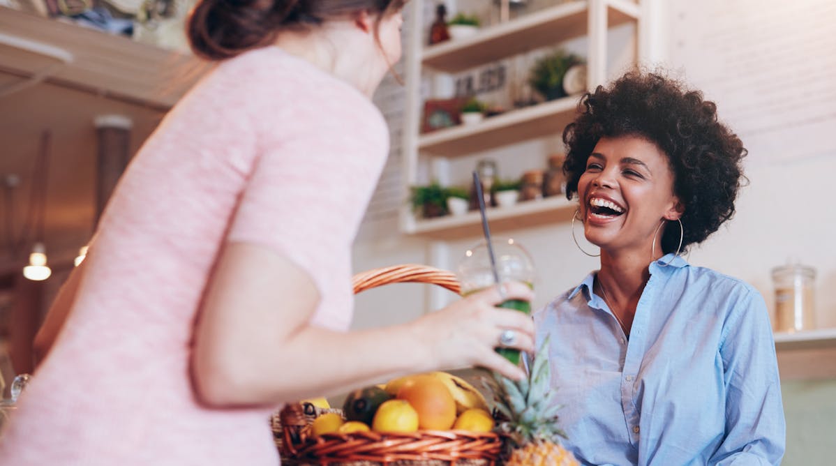 Shop worker smiling with customer