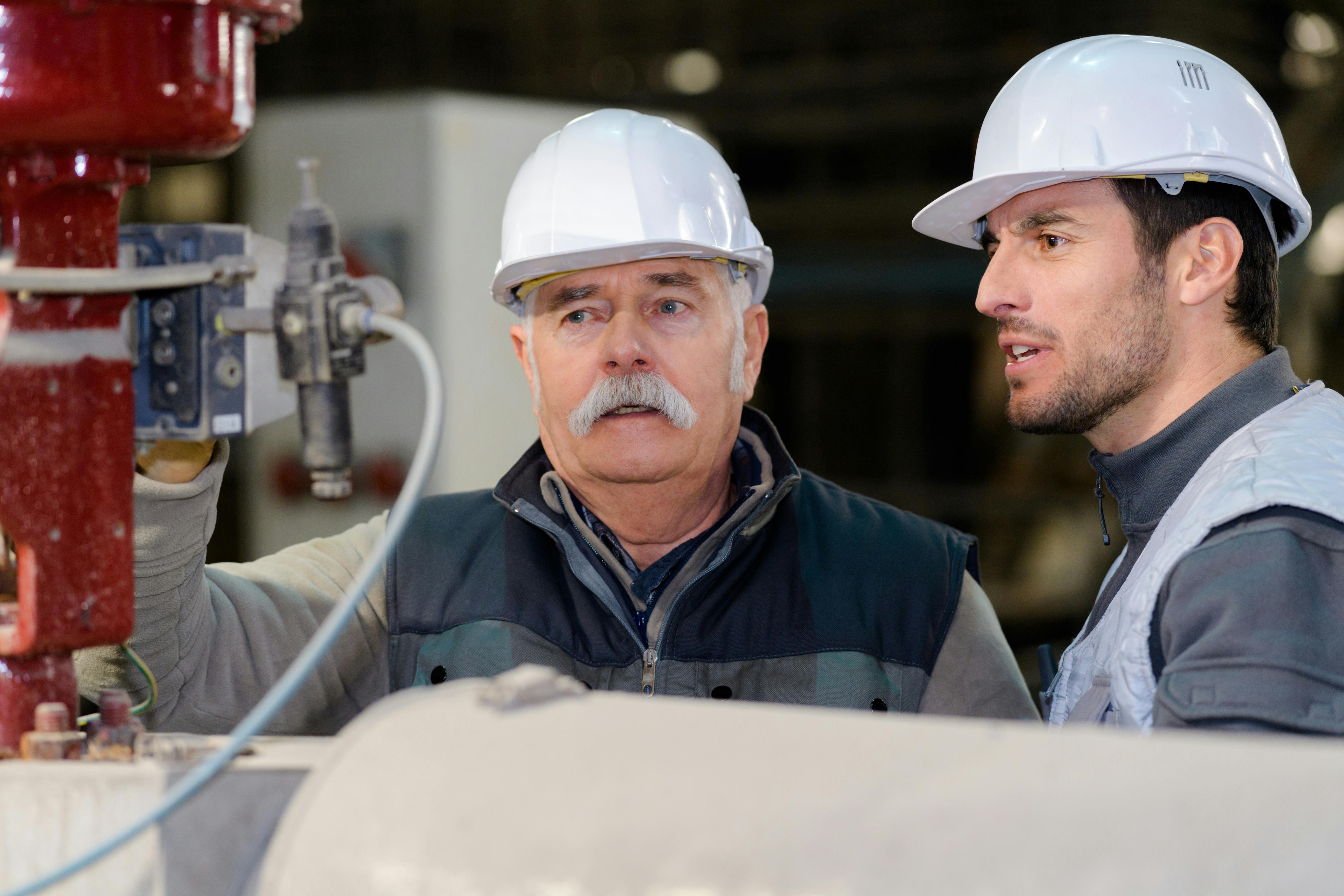 A senior technician and junior engineer discuss institutional knowledge and best practices for the management of their facilities and equipment.