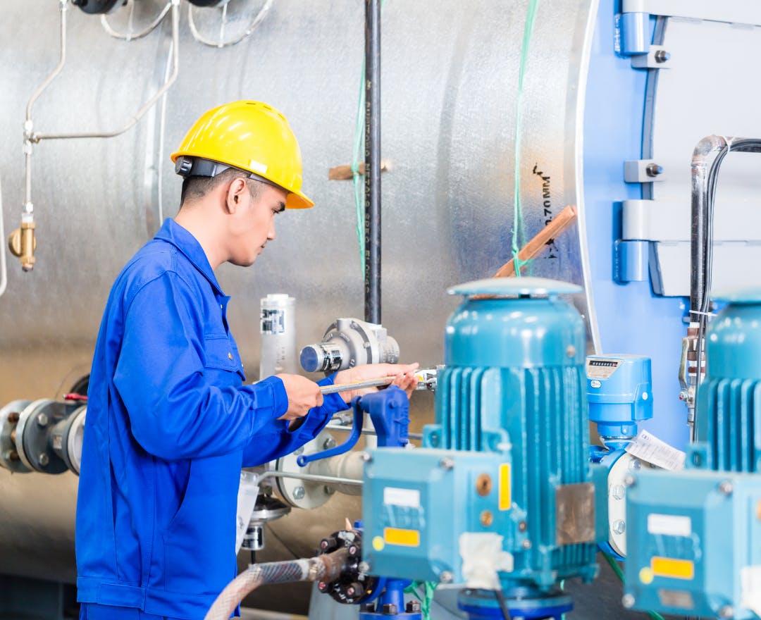 A technician works on site after completing site-specific training on the Aetos Operate platform.