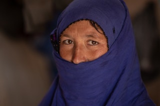 A woman in a blue hijab.
