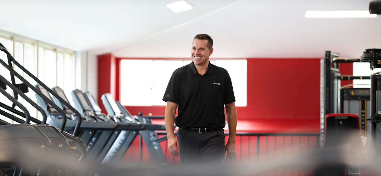 Chris Caldwell, CEO of SNAP Fitness among treadmills at Brisbane SNAP