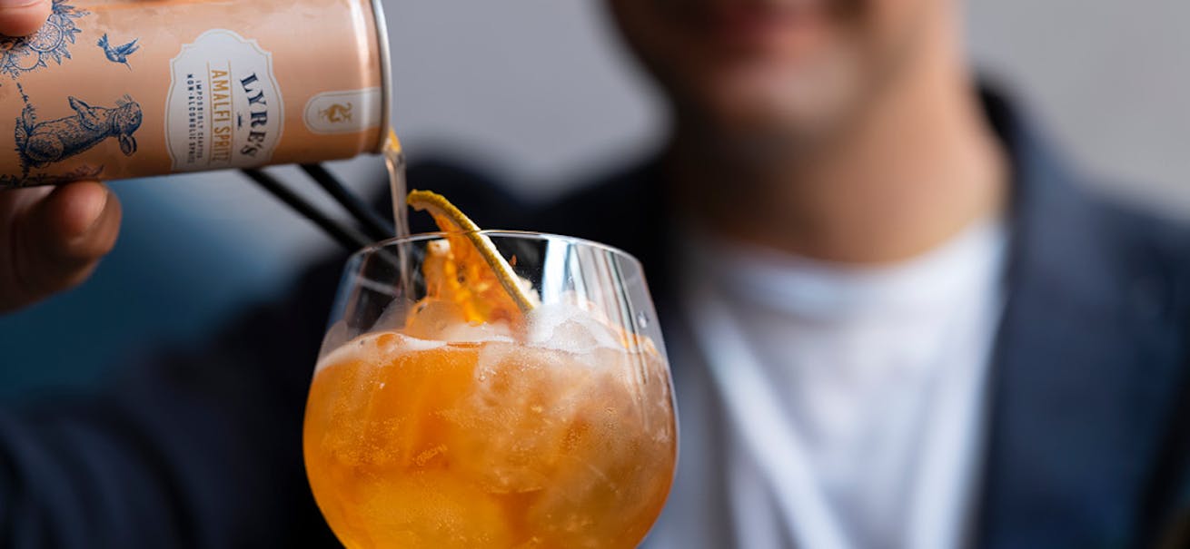 Carl Hartmann with a Lyre's Spirit Co cocktail
