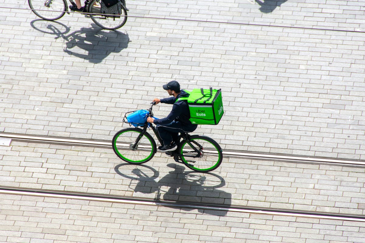 Photograph of Uber cyclist from above on a city street