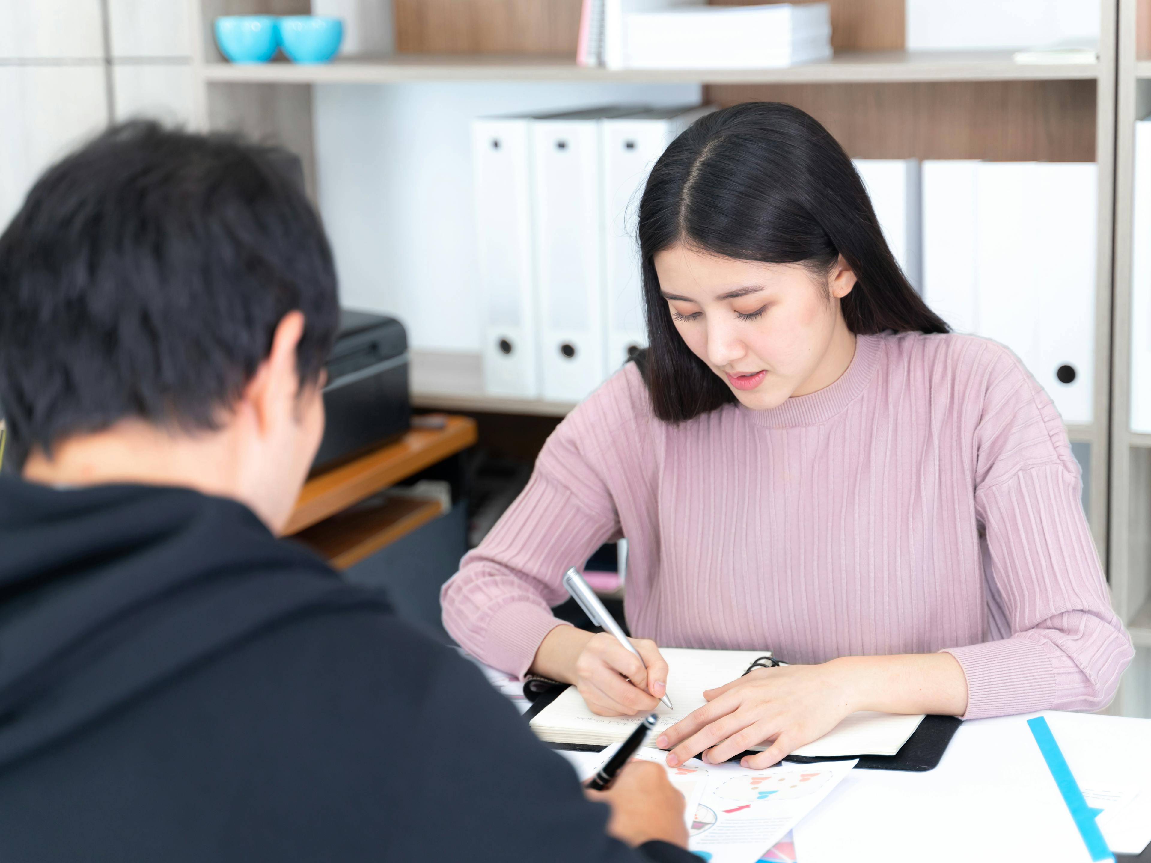 Photo of a woman jotting down notes