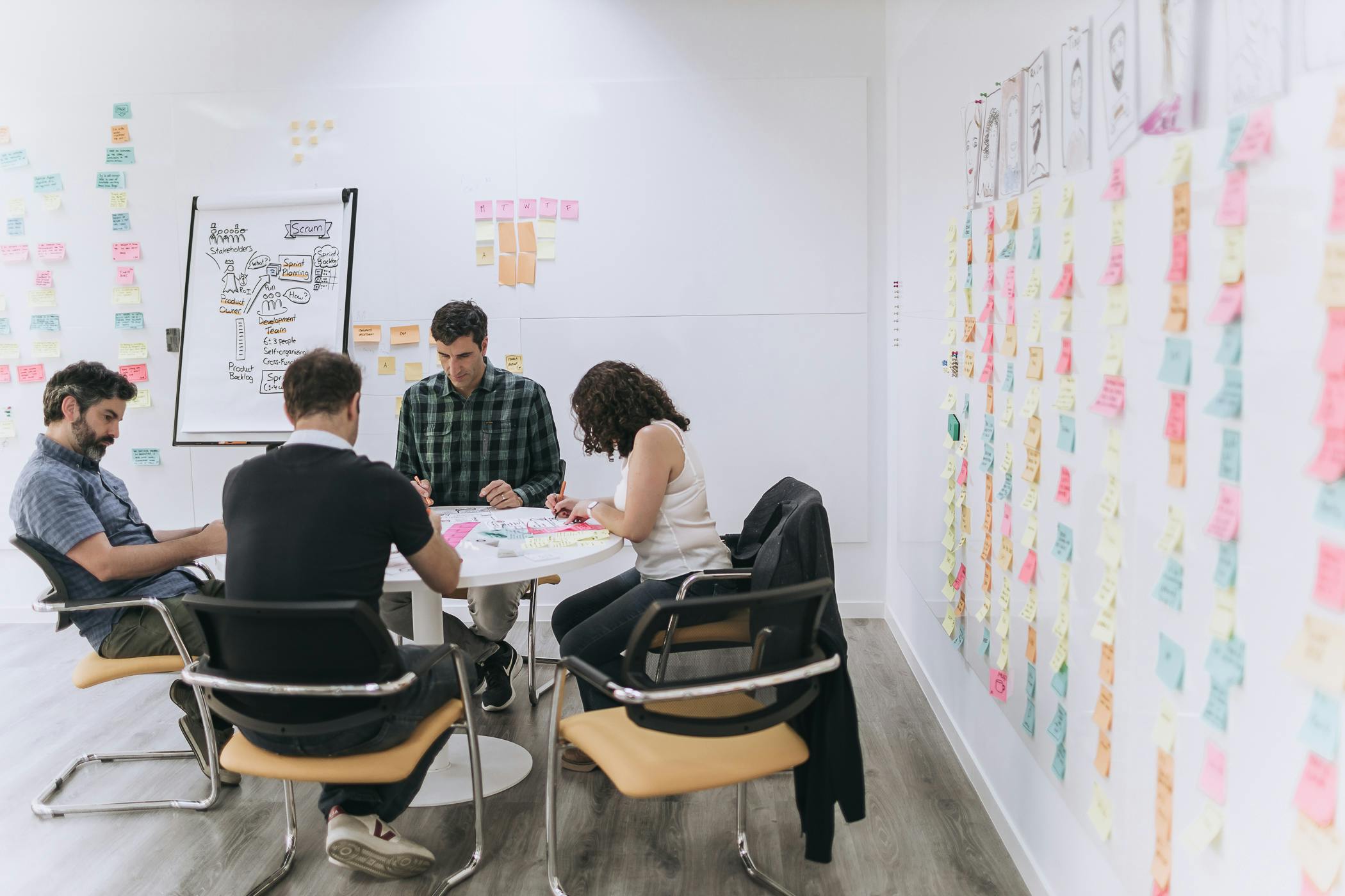 A group of people sitting down in an office working as a team