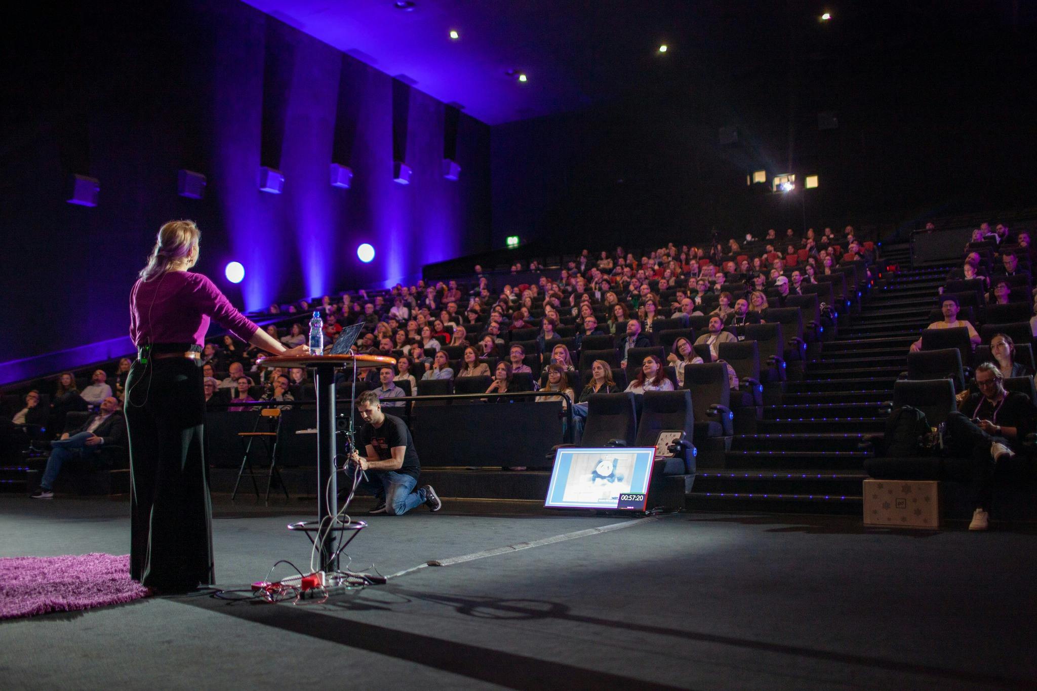 Typical scene of a conference where a person is presenting in front of an audience